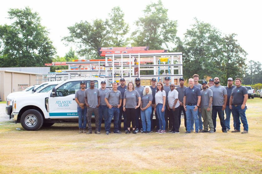 The Atlantic Glass team in front of company vehicles
