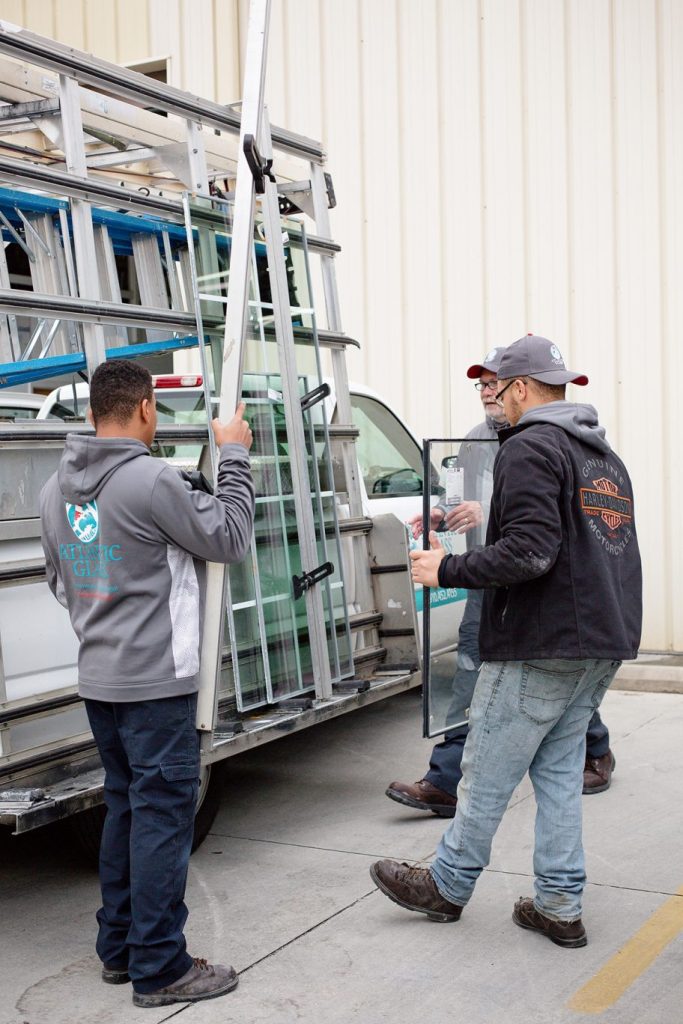 Atlantic Glass technician loading glass panels onto a truck rack