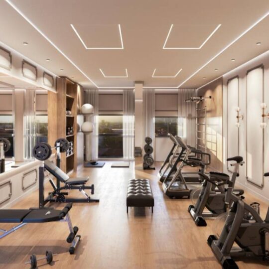 A fitness studio with a full mirrored wall behind the equipment