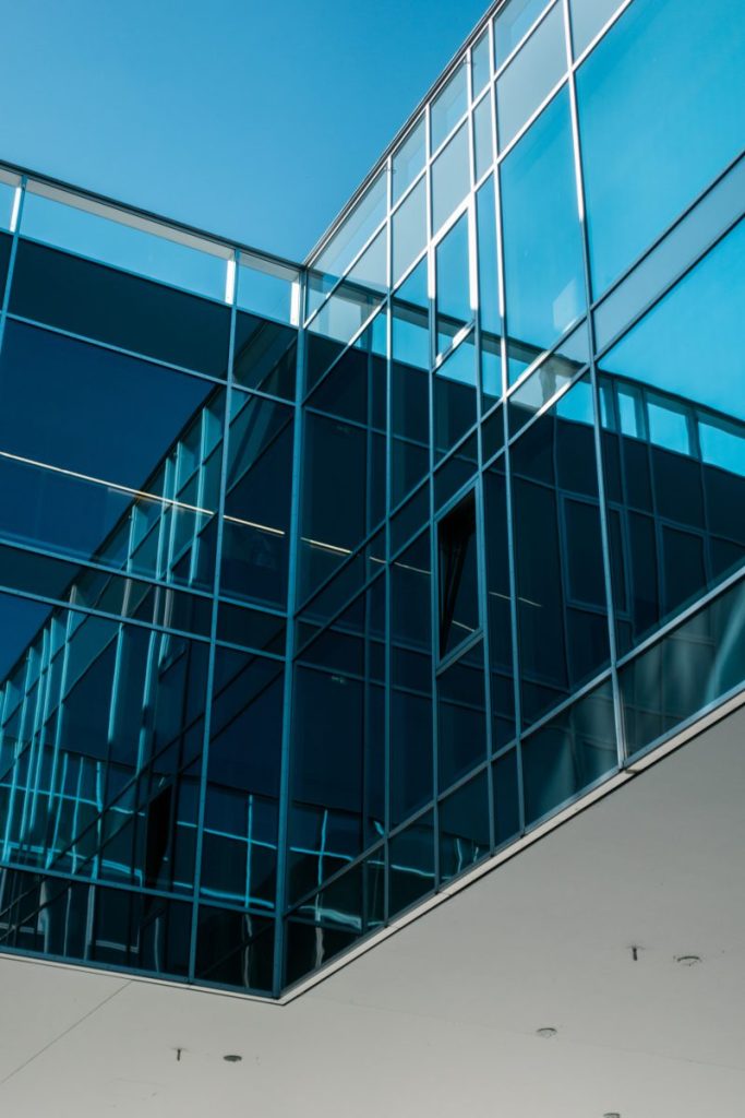 Blue-tinted curtain wall glazing seen from below