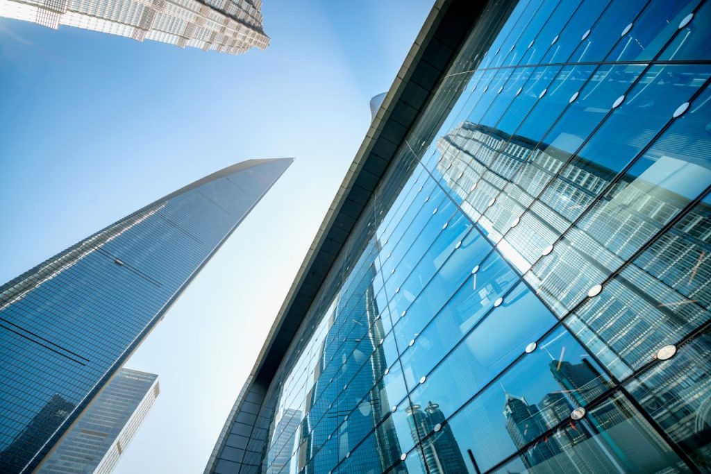 Glass-clad commercial towers seen from street level