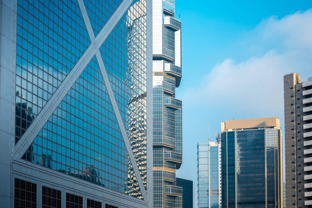 Glazed high-rise buildings against a clear blue sky