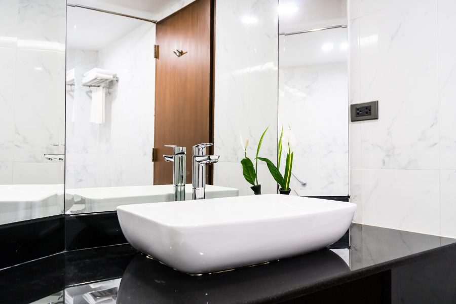 Bathroom with a frameless glass mirror and vessel basin