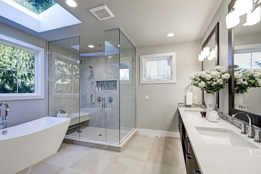Frameless glass shower enclosure in a tiled bathroom