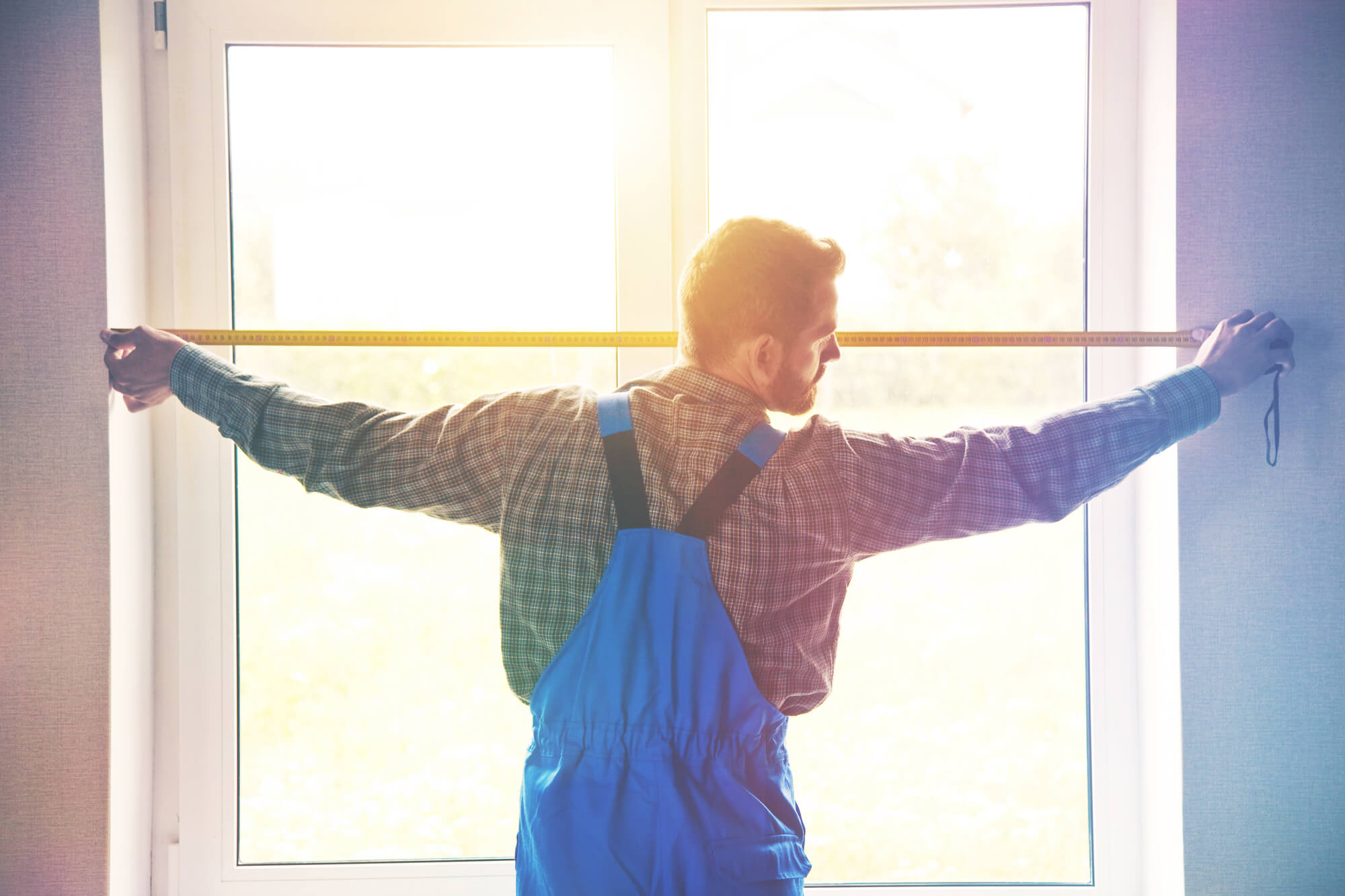 Atlantic Glass technician repairing a window, close-up view